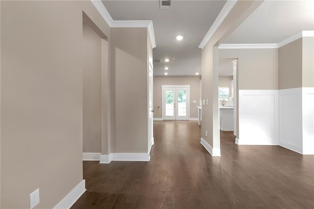 hall featuring ornamental molding, dark wood-type flooring, and french doors