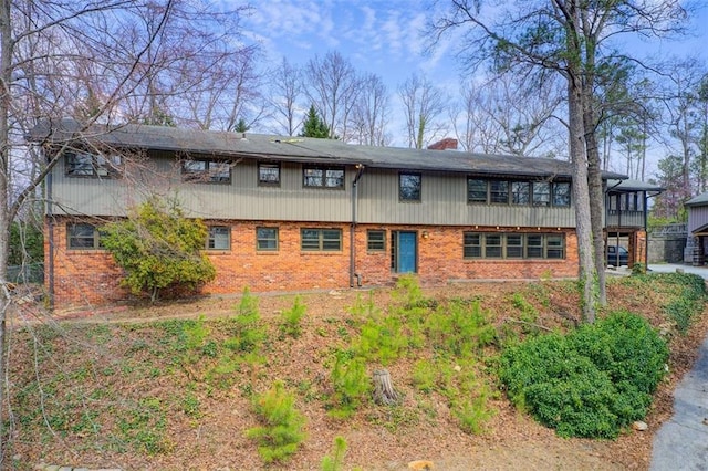 exterior space with a chimney and brick siding