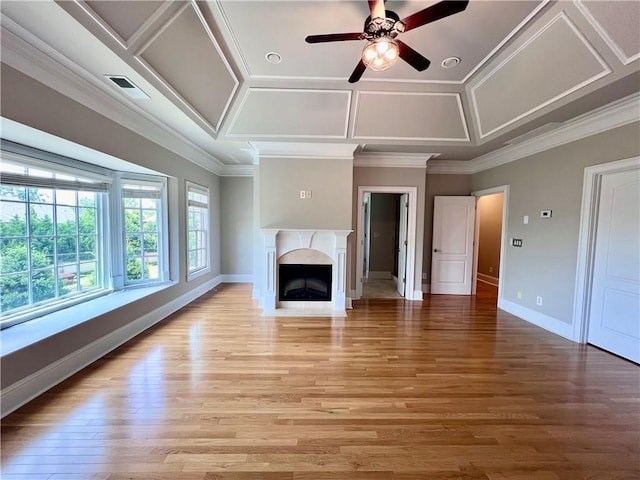 unfurnished living room with ornamental molding, a premium fireplace, coffered ceiling, and hardwood / wood-style floors