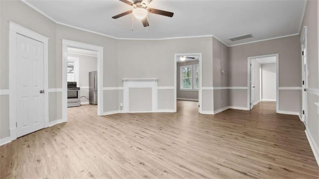 spare room featuring ornamental molding, ceiling fan, and light wood-type flooring