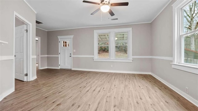 spare room with ornamental molding, light hardwood / wood-style floors, and ceiling fan