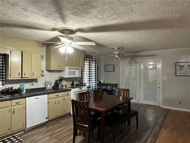 kitchen with a ceiling fan, dark countertops, a textured ceiling, white appliances, and dark wood-style flooring