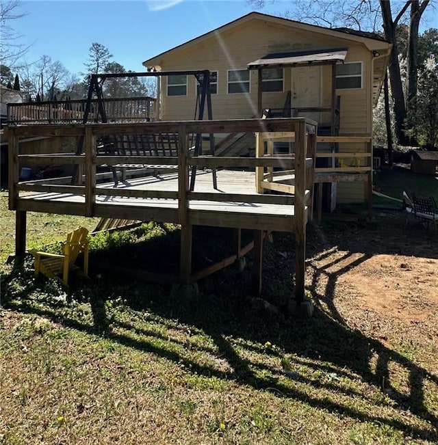 back of house with a deck