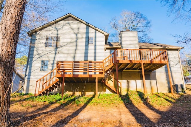 back of property with stairs, central AC unit, a chimney, and a deck