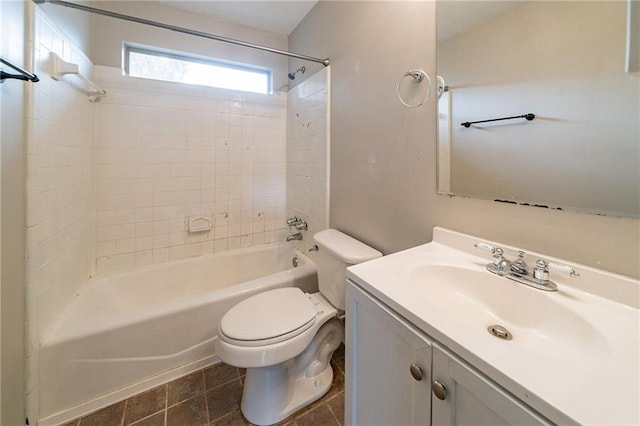 full bathroom featuring vanity, tiled shower / bath combo, tile patterned floors, and toilet