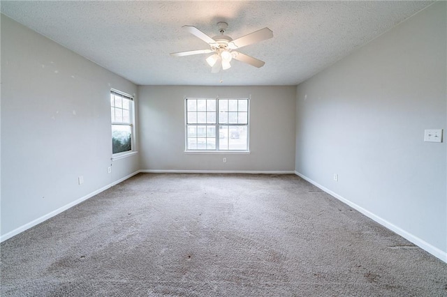 spare room with ceiling fan, carpet floors, and a textured ceiling