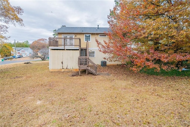 back of property with a yard, central AC unit, and a wooden deck