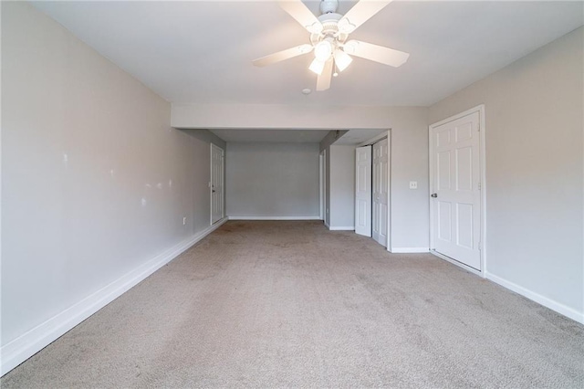 spare room with light colored carpet and ceiling fan