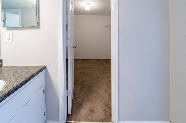 bathroom with vanity and a textured ceiling