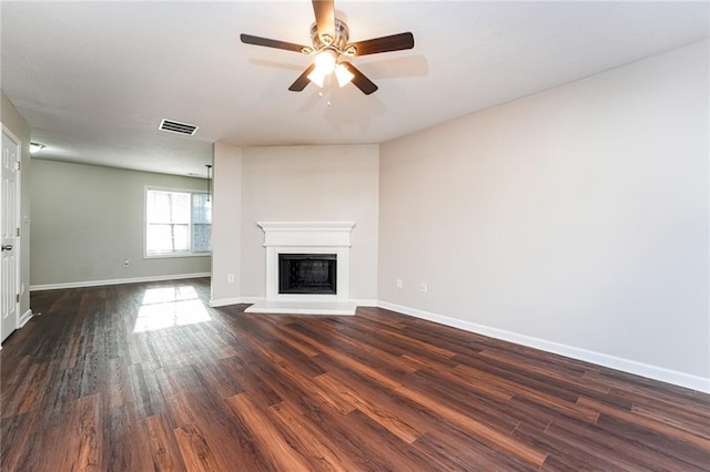 unfurnished living room with dark hardwood / wood-style floors and ceiling fan