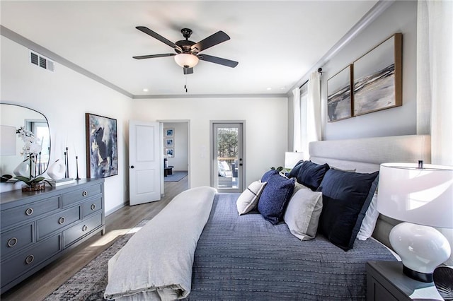 bedroom with ceiling fan, access to exterior, ornamental molding, and hardwood / wood-style floors