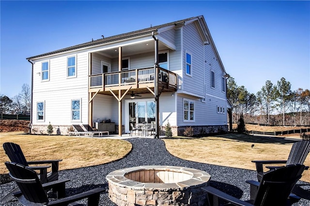 back of house featuring a balcony, a fire pit, and a patio