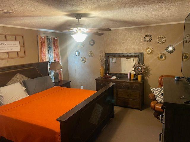 1167 Underwood Rd, Sparta, GA 31087 - bedroom featuring ornamental molding, a textured ceiling, light colored carpet, a ceiling fan, and a desk