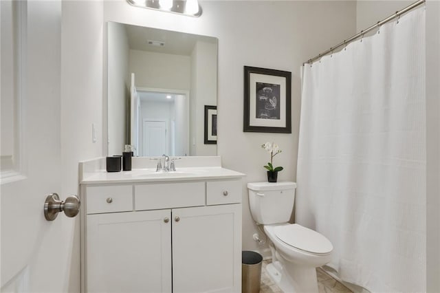 full bathroom with toilet, vanity, and visible vents