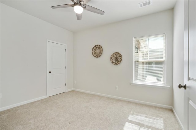 unfurnished room featuring light carpet, ceiling fan, visible vents, and baseboards