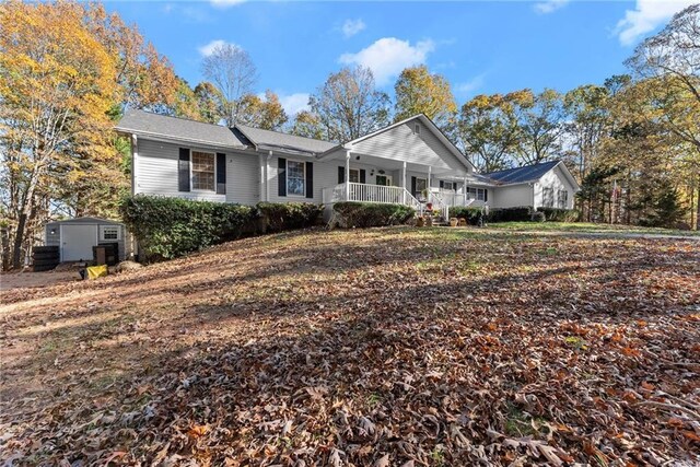 305 Mountain Brook Rd, Dawsonville, GA 30534 - ranch-style home with a porch, a storage shed, and an outdoor structure