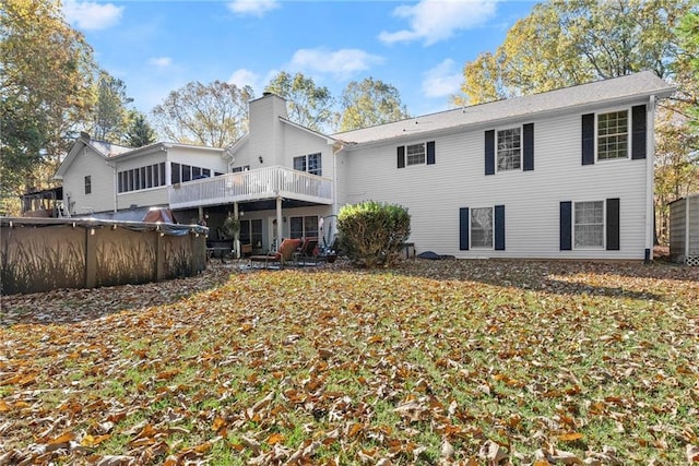 305 Mountain Brook Rd, Dawsonville, GA 30534 - rear view of house with a chimney, a deck, and a covered pool