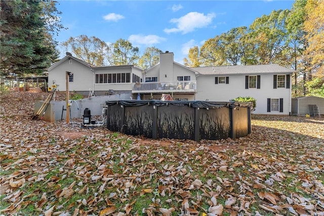 305 Mountain Brook Rd, Dawsonville, GA 30534 - back of house featuring a covered pool and a chimney
