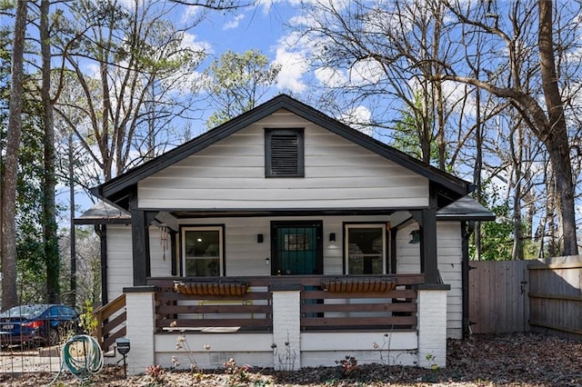 bungalow-style house featuring a fenced front yard, a gate, and a porch