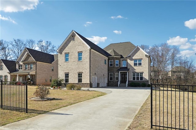 traditional-style home with a front yard, concrete driveway, fence, and an attached garage