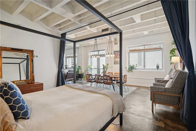 bedroom featuring a chandelier, beam ceiling, and multiple windows