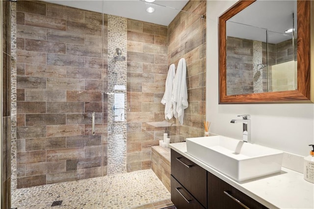 bathroom with vanity and a shower with shower door