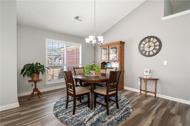 dining area with lofted ceiling, a notable chandelier, and dark hardwood / wood-style flooring