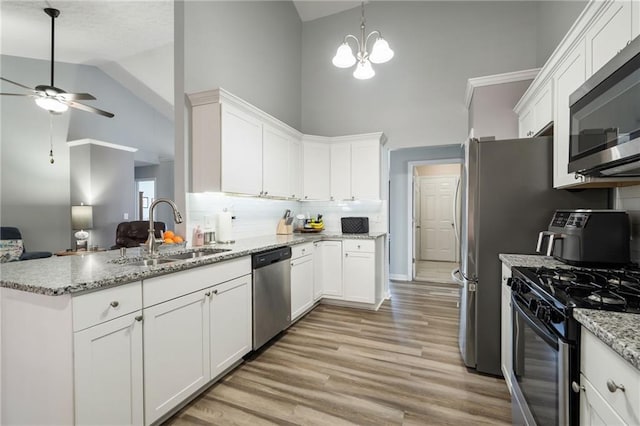 kitchen with stainless steel appliances, sink, and white cabinets