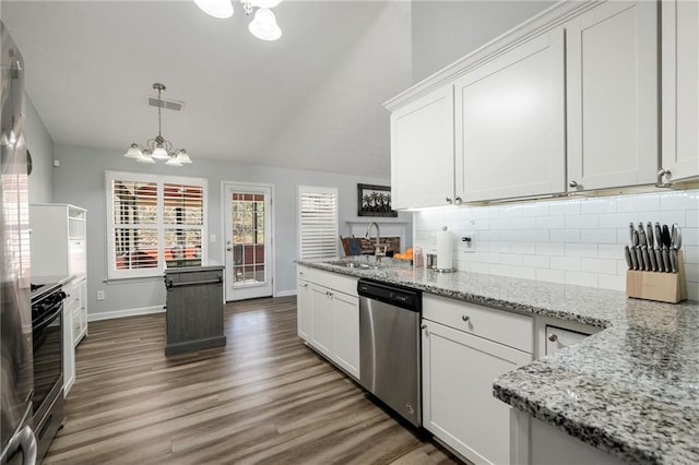 kitchen with an inviting chandelier, stainless steel appliances, and white cabinets