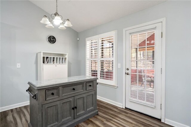 kitchen featuring white cabinetry, stainless steel dishwasher, a stone fireplace, and sink