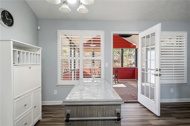 interior space featuring dark hardwood / wood-style floors, a notable chandelier, and french doors