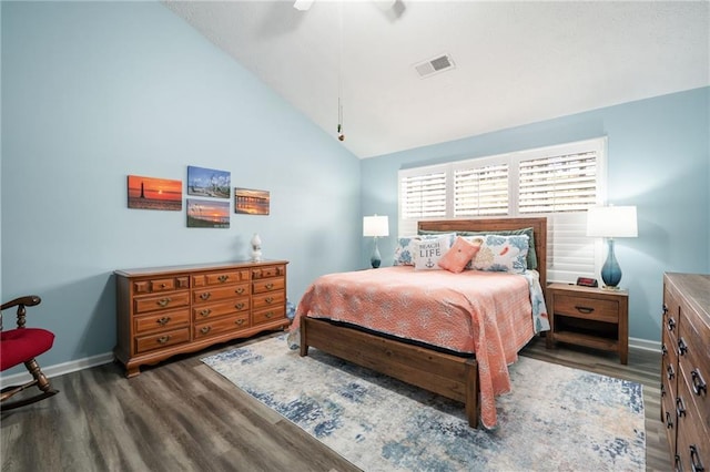 bedroom featuring ceiling fan, lofted ceiling, and dark hardwood / wood-style flooring