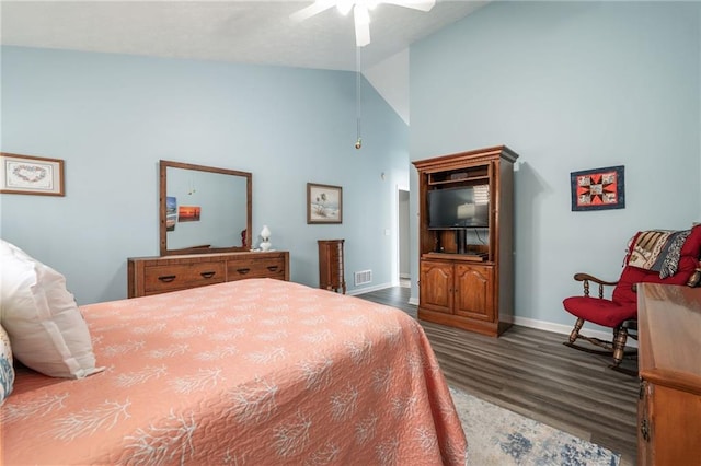 bedroom with ceiling fan, dark wood-type flooring, and high vaulted ceiling