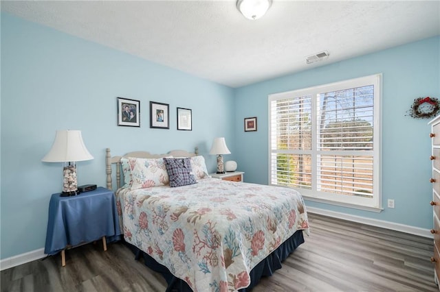 bedroom with dark hardwood / wood-style flooring