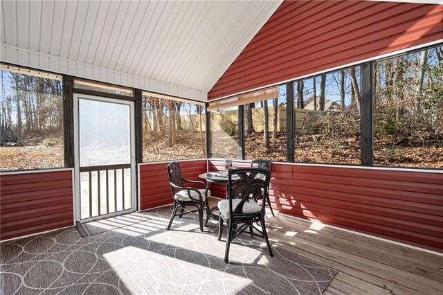 unfurnished sunroom with lofted ceiling