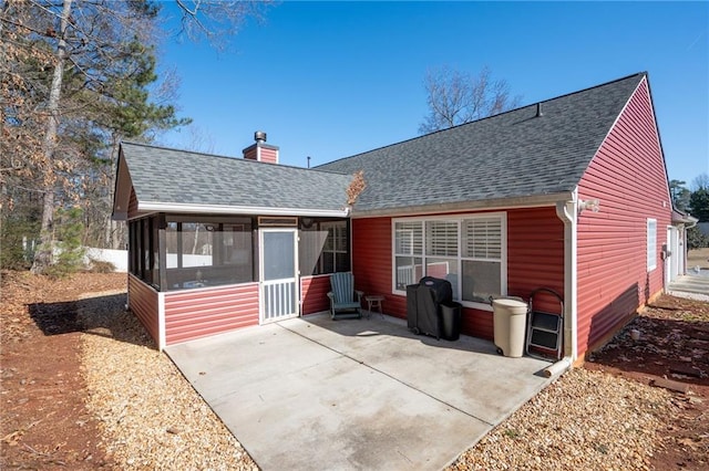 rear view of property featuring a sunroom and a patio