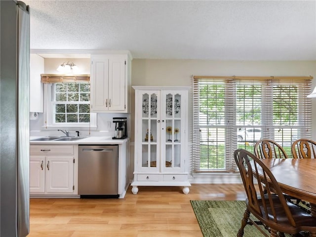 5020 Bayberry Dr, Cumming, GA 30040 - kitchen with appliances with stainless steel finishes, light countertops, white cabinetry, light wood-style flooring, and a textured ceiling