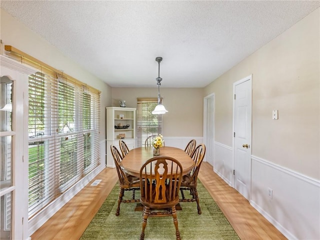 5020 Bayberry Dr, Cumming, GA 30040 - dining room with a textured ceiling and light wood-style flooring