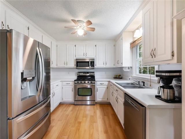 5020 Bayberry Dr, Cumming, GA 30040 - kitchen featuring stainless steel appliances, light wood-style flooring, a textured ceiling, light countertops, and white cabinets