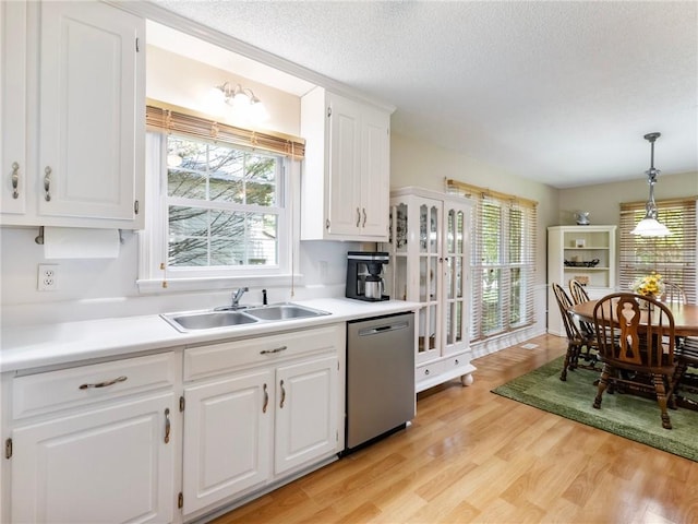 5020 Bayberry Dr, Cumming, GA 30040 - kitchen featuring dishwasher, light countertops, white cabinetry, light wood-style flooring, and a textured ceiling