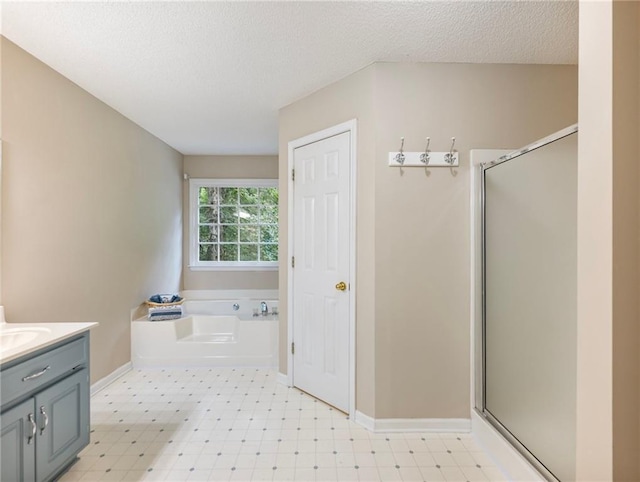 5020 Bayberry Dr, Cumming, GA 30040 - full bath featuring tile patterned floors, a shower stall, a garden tub, vanity, and a textured ceiling