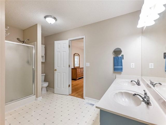 5020 Bayberry Dr, Cumming, GA 30040 - bathroom with a shower stall, double vanity, tile patterned floors, and a textured ceiling
