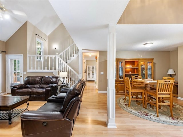 5020 Bayberry Dr, Cumming, GA 30040 - living room featuring light wood finished floors, stairway, and decorative columns