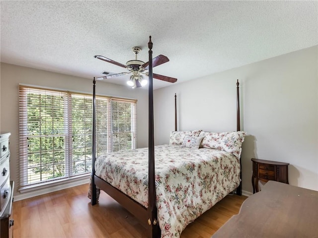 5020 Bayberry Dr, Cumming, GA 30040 - bedroom with wood finished floors, a ceiling fan, and a textured ceiling