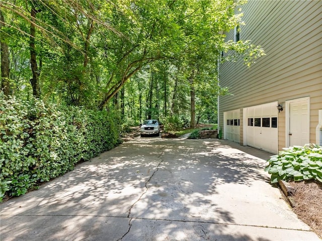5020 Bayberry Dr, Cumming, GA 30040 - view of side of home featuring concrete driveway and a garage