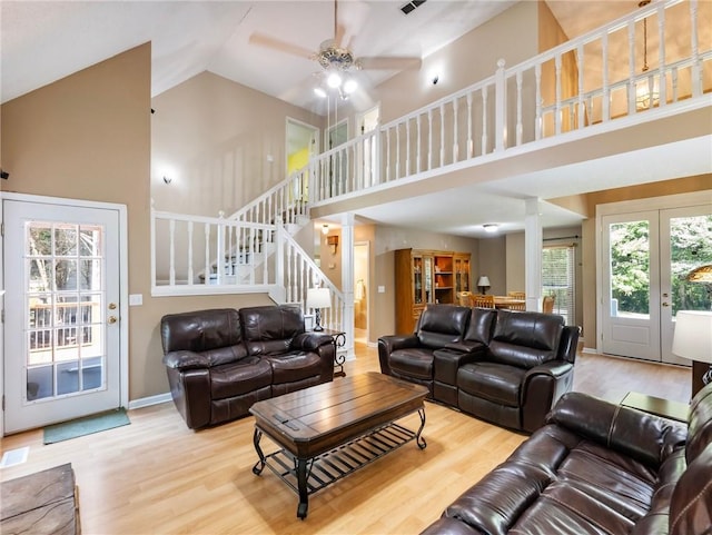5020 Bayberry Dr, Cumming, GA 30040 - living room with high vaulted ceiling, decorative columns, ceiling fan, wood finished floors, and stairs