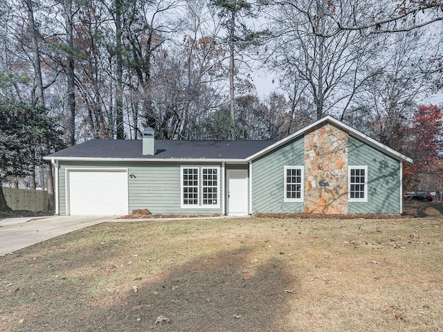 ranch-style house featuring a front yard and a garage