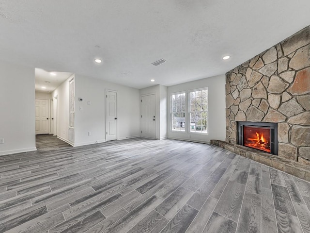 unfurnished living room featuring a fireplace and hardwood / wood-style flooring