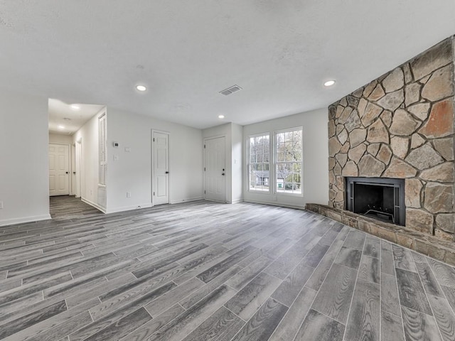 unfurnished living room featuring a fireplace and hardwood / wood-style floors