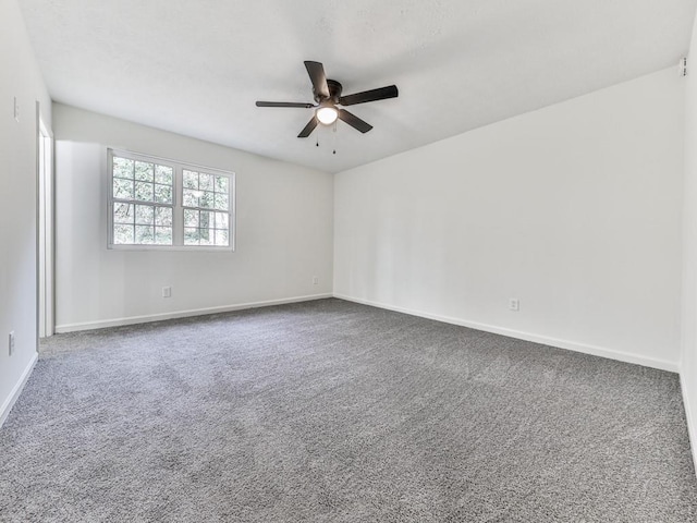 spare room with carpet and ceiling fan